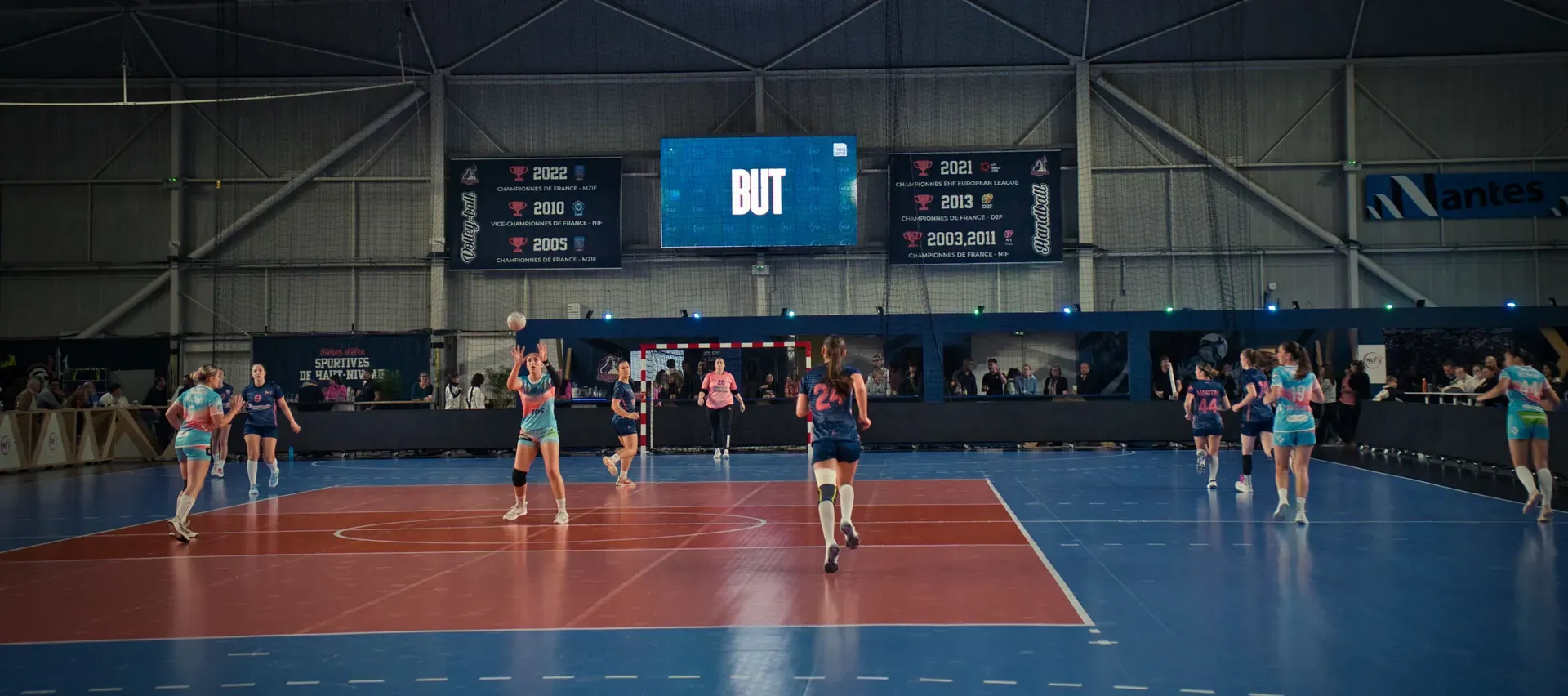 Neopro digital screen displaying sponsor content in a handball gym